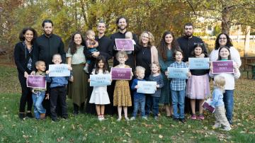 Families holding Thank You signs