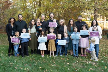 Families holding Thank You signs